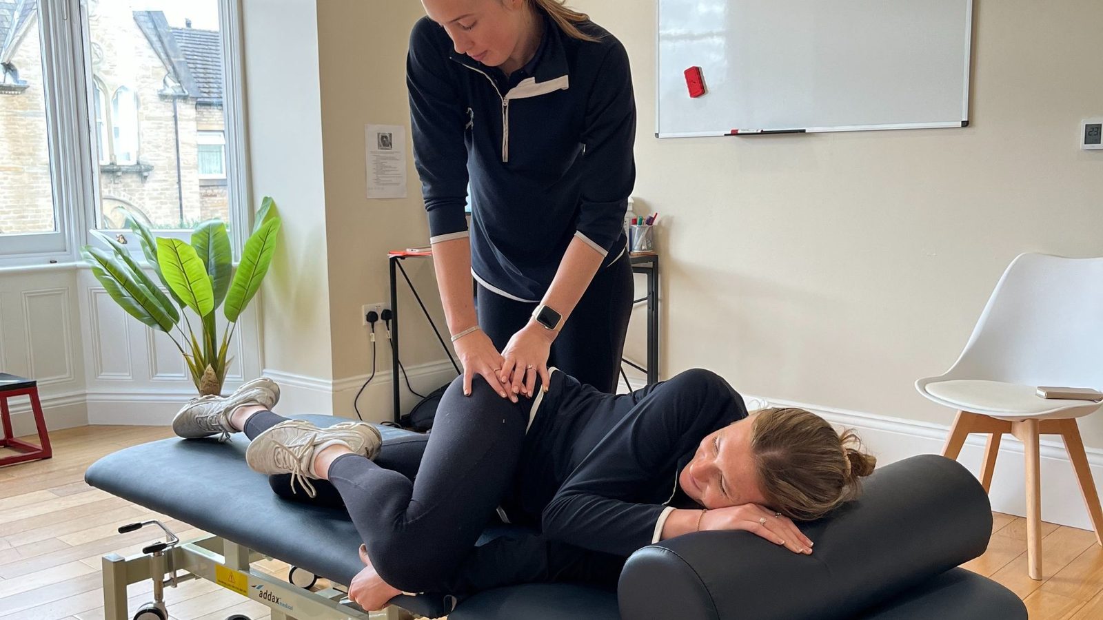 One of the ProSport therapists treating a patient in a treatment room at Pro Sport House, Huddersfield.